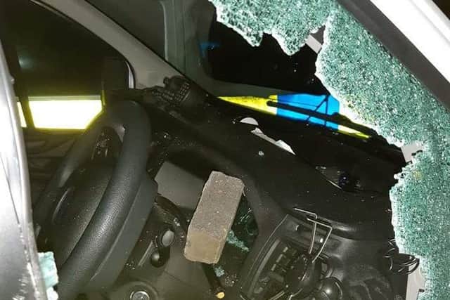 A brick thrown into a police van last night