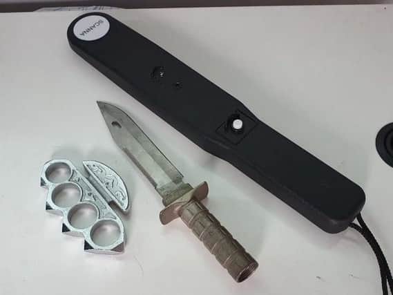 One of Lancashire's new knife wands, pictured beside a blade and a knuckle-duster (Picture: Chris Webb, deputy police and crime commissioner for Lancashire)