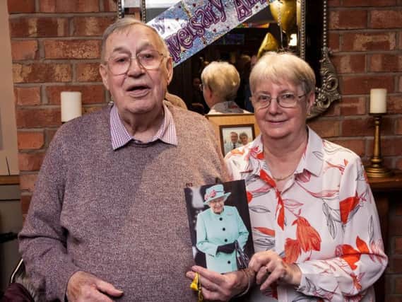 Ken and Kath Downing, of Leyland, celebrating their 60th wedding anniversary. They are pictured with their card from the Queen.