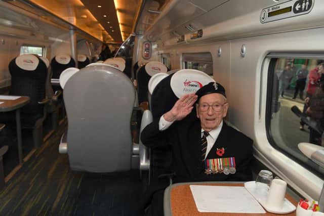 Ernest saluting on the train