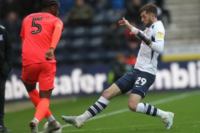 Preston winger Tom Barkhuizen challenges Huddersfield's Terence Kongolo