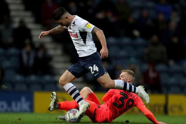 Preston's Sean Maguire rides a challenge from Huddersfield's Lewis O'Brien