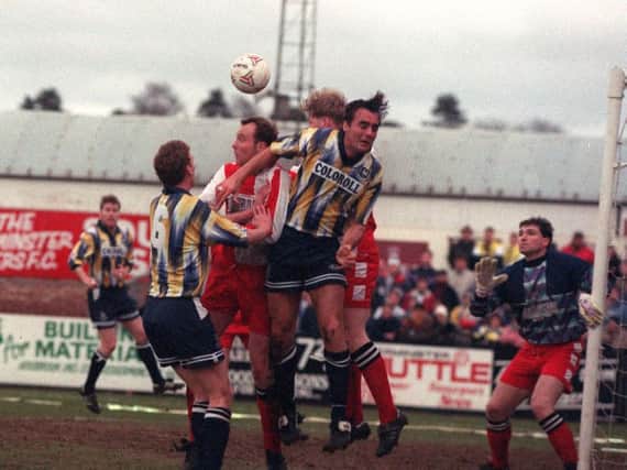Preston striker Mike Conroy and defender David Moyes challenge in the Kidderminster box in the FA Cup in January 1994