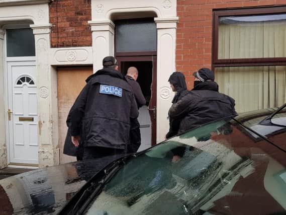 Officers used power tools to enter the terraced home and arrested two occupants, a 47-year-old man and a 42-year-old woman on suspicion of drug dealing. Pic: Lancashire Police