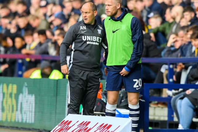 Jayden Stockley gets instructions from Alex Neil before coming on against Blackburn