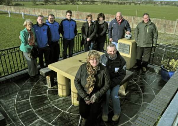 Well cared for: Karen Bradley, husband Kevin plus  friends and Wyre Villa FC members in the memorial area