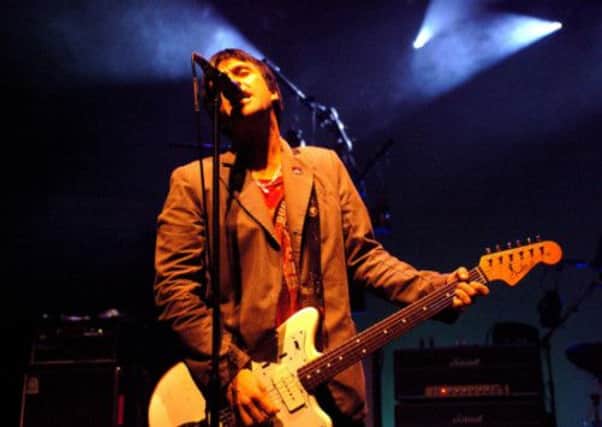 Johnny Marr (formerly of The Smiths) playing with his band, Modest Mouse
