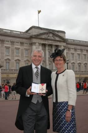 Stephen Henwood CBE with wife Rev Gill Henwood, pictured outside Buckingham Palace