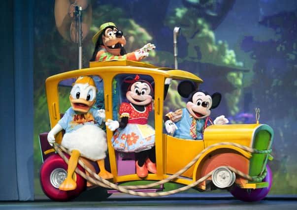 Walt Disneys famous creations Mickey Mouse, Goofy, Minnie and Donald Duck on stage in Disney Live! Mickeys Rockin Road Show