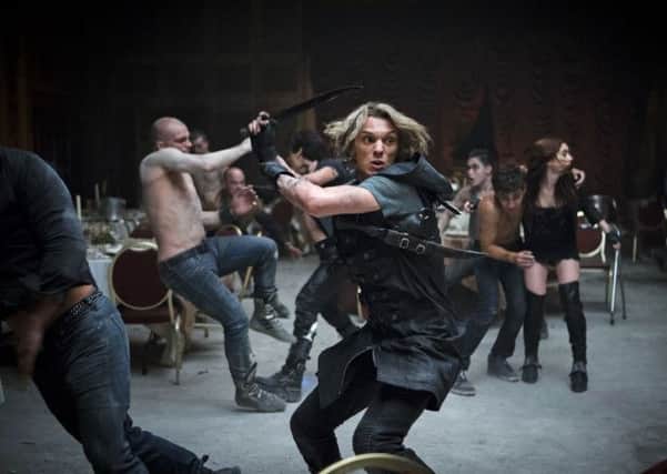 Jace (Jamie Campbell Bower) takes on the Vampires,  Alec (Kevin Zegers), Clary (Lily Collins) and Simon (Robert Sheehan)