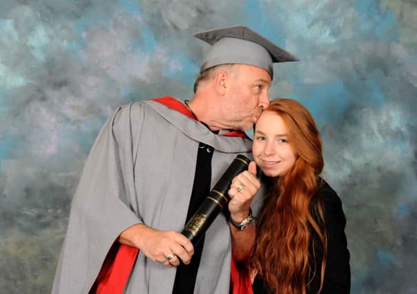 Peter Hook receives his honorary degree at UCLan, with his daughter Jess