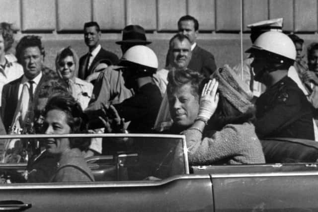 President John F. Kennedy riding in a motorcade with his wife Jacqueline, right, Nellie Connally, left, and her husband, Gov. John Connally of Texas in Dallas, Texas.,  prior to President Kennedy's assassination