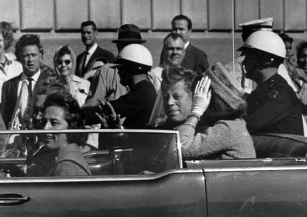 President John F. Kennedy riding in a motorcade with his wife Jacqueline, right, Nellie Connally, left, and her husband, Gov. John Connally of Texas in Dallas, Texas.,  prior to President Kennedy's assassination