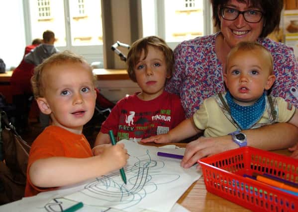 Anna Rogerson with her children, Ted Walmsley, two, Joe Walmsley, four and Sam Walmsley, one from Fulwood at the Harris Museum and Library