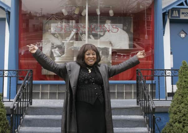Martha Reeves standing in front of the Motown museum Hitsville USA. in Detroit