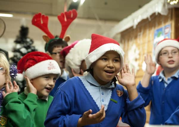 Pupils from Lea Community Primary School and the Royal Cross Primary School signing and singing Christmas Carols at the indoor market in Preston