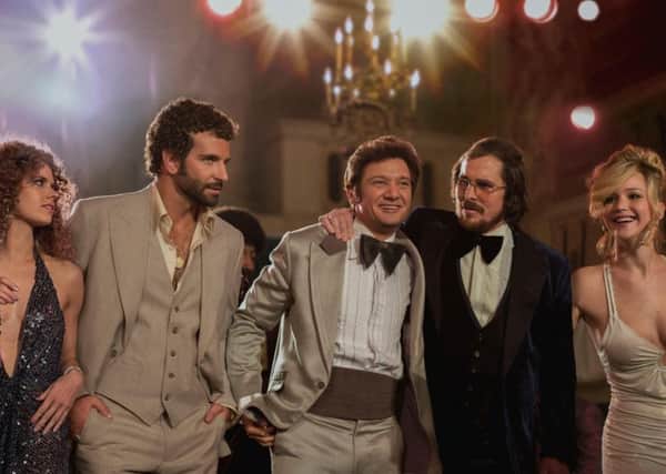 American Hustle: (l to r) Amy Adams, Bradley Cooper, Jeremy Renner, Christian Bale and Jennifer Lawrence