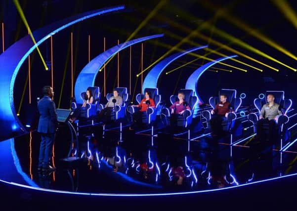 Presenter Andi Peters faces six contestants on the Ejector Seat set