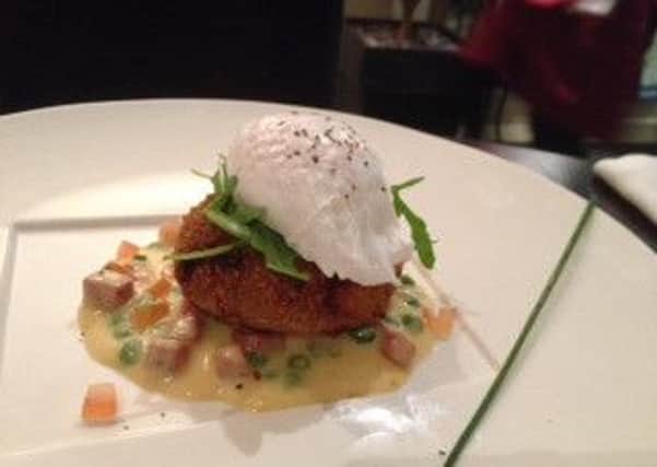 kedgeree-style fish cakes topped with poached egg, fresh rocket, chorizo and pea veloutee
