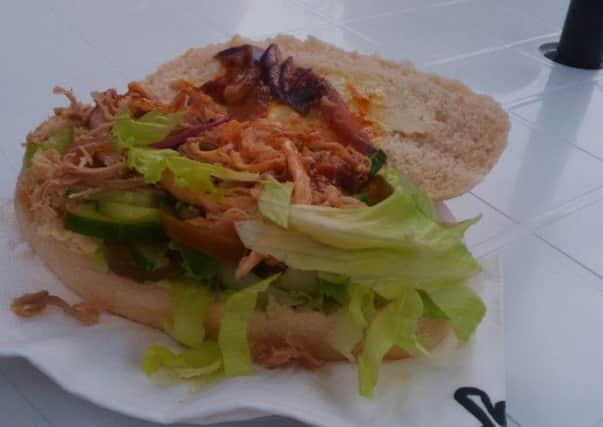 Pulled pork sandwich with lima pickles, salad and a generous squirt of peri peri sauce