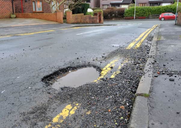 Menace: One of 92,000 holes in Lancashire soon to be filled in
