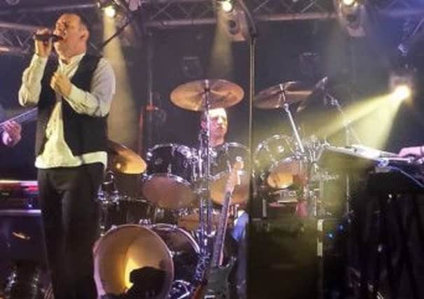 John Wilkinson (left) the lead singer with Genesis tribute band band, Mama.