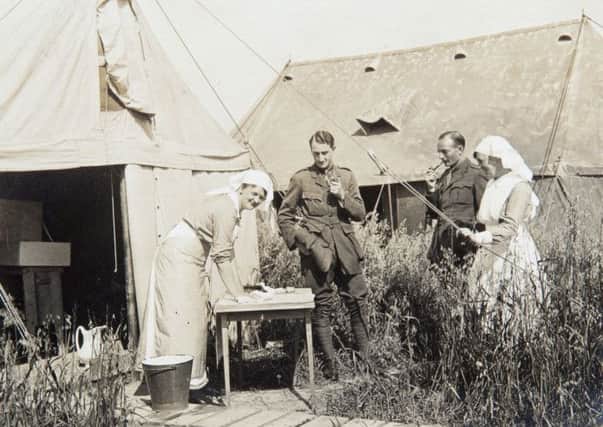 A nurse doing laundry at Bourbourg camp circa 1915. A basin used for laundry can glimpsed within the tent