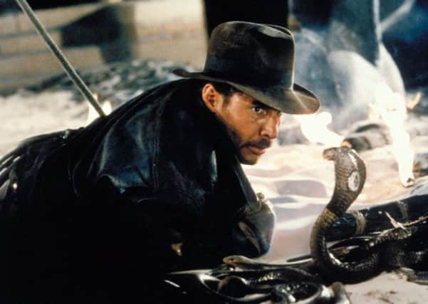 Actor Harrison Ford comes face-to-face with a cobra in a scene from the Indiana Jones adventure "Raiders of the Lost Ark