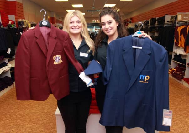 School Uniform Sizes from a size 28 to size 52 blazer at Monkhouse Schoolwear in Fishergate, Preston.
Pictured are sales assistants Amy Ellis and Hana El-Haroun with the two sizes of blazers