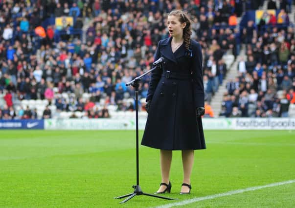 BC Young Chorister of the Year Louisa Stirland  performs on the Deepdale pitch before kick