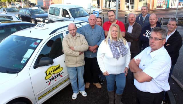 Call: John Gregory (front right) with fellow taxi drivers, who are urging the council to rethink a rule change