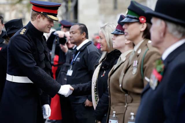 Prince Harry meets widow Lisa McKinlay as he arrives to open the 86th Field of Remembrance at Westminster Abbey, London.