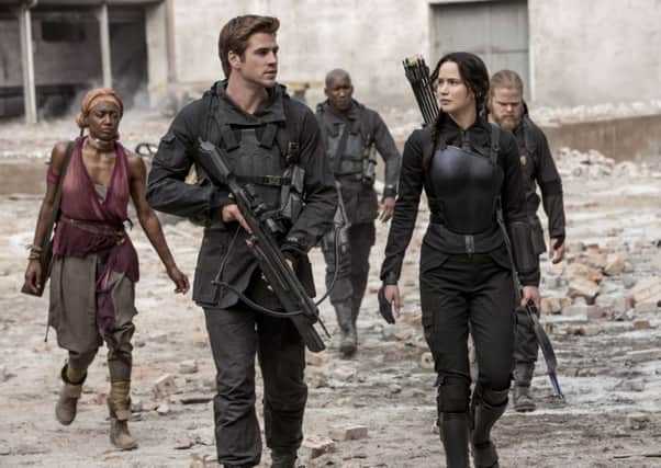 The Hunger Games: Mockingjay Part 1. Pictured: Liam Hemsworth and Jennifer Lawrence