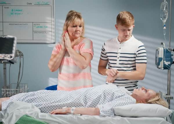 Beth Sutherland (Lisa George) and Chesney Battersby Brown (Sam Aston) at the hospital bedside of Sinead Tinker (Katie McGlynn)