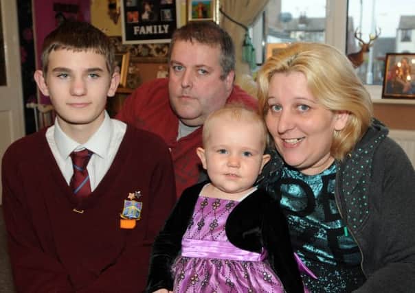 Photo: David Hurst
Jessica Holmes, two, of Toulmin Close, Catterall near Garstang, who has leukaemia pictured with mum Mandy, dad Bob and brother Dylan Byers and the necklaces made from beads given to her each time she has some treatment