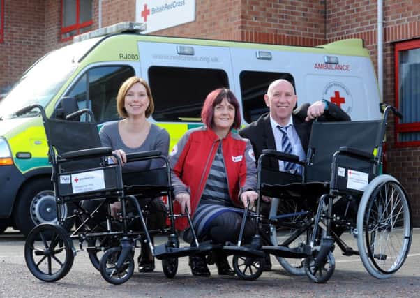 Photo Neil Cross
Jackie Humpries and Alan Beauchamp of Westinghouse Springfields present the first of 10 new wheelchairs to Sarah Collins of British Red Cross in Fulwood, Preston
