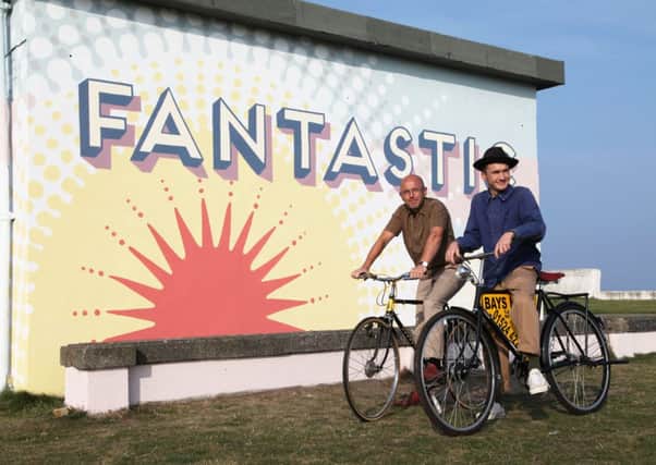 Wayne Hemingway and his son Jack cycle along the promenade ahead of the Vintage Festival.