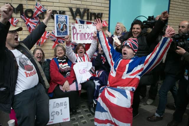 Royal fans and wellwishers react outside the Lindo Wing of St Mary's Hospital in Paddington, London, after Kensington Palace announced that the Duchess of Cambridge had given birth to a girl