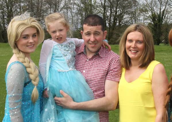 PARTY: Sophie Bayliss with Queen Elsa and parents Grant and Amanda