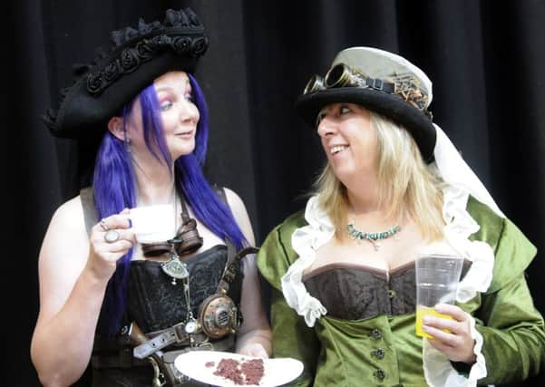 Steampunks Kirsty Railton and Rose Roberts engage in some tea duelling.