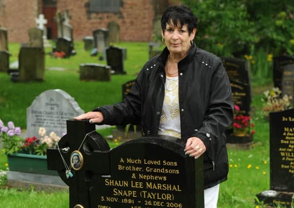 Denise Taylor at the grave of her grandsons Shaun and Toby after sentimental items were stolen