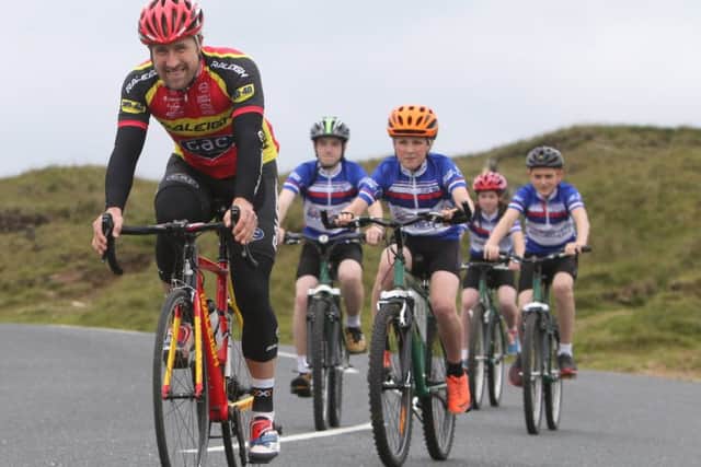 Cyclist Ian Wilkinson leads students from Ribblesdale High School up Pendle Hill at the launch of the Stage 2 Tour of Britain.