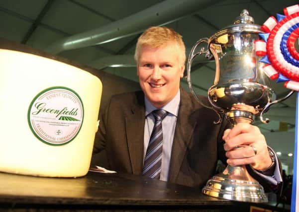 Steven Procter with the winning cheese and trophy.