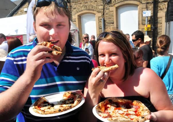 Photo: David Hurst
Clitheroe Food Festival.
Tucking into  a couple of pizza's are Will and Dawn Horner