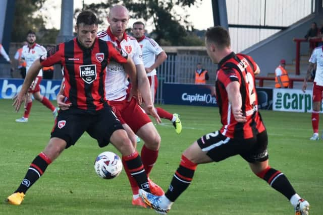 Ryan Edwards tries to hold on to possession.