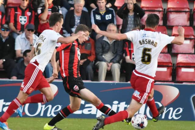Morecambe midfielder Andy Fleming is surrounded against Sheffield United.