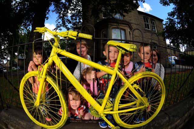 exciting times: Staff and children at Little People at the Limes nursery in Longridge with a yellow bike