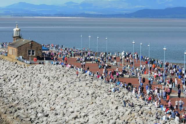 Morecambe's Vintage Festival came to a fitting climax with the fly-past of the only two airworthy Lancaster bombers in the world.
Crowds line the promenade to watch the historic aircraft.  PIC BY ROB LOCK
7-9-2014