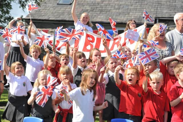 Photo Neil Cross
 The Tour of Britain heads through Chatburn
 as Primary School pupils turn out to cheer it on