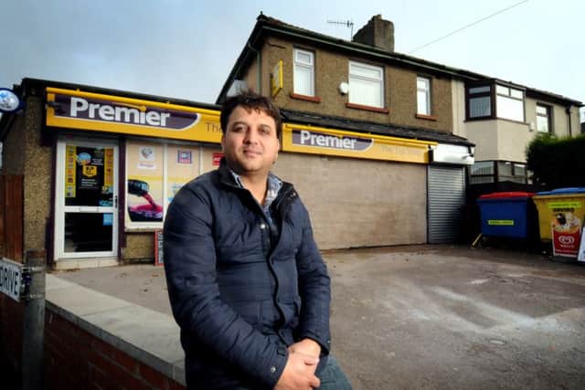 Shop owner Shahid Chughtai outside the Premier Top Shop on Cog Lane in Burnley, where a car was  smashed through the front wall